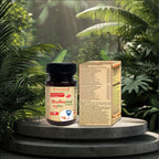 Ayurvedic medicine bottle and packaging on a stone platform with green foliage in the background